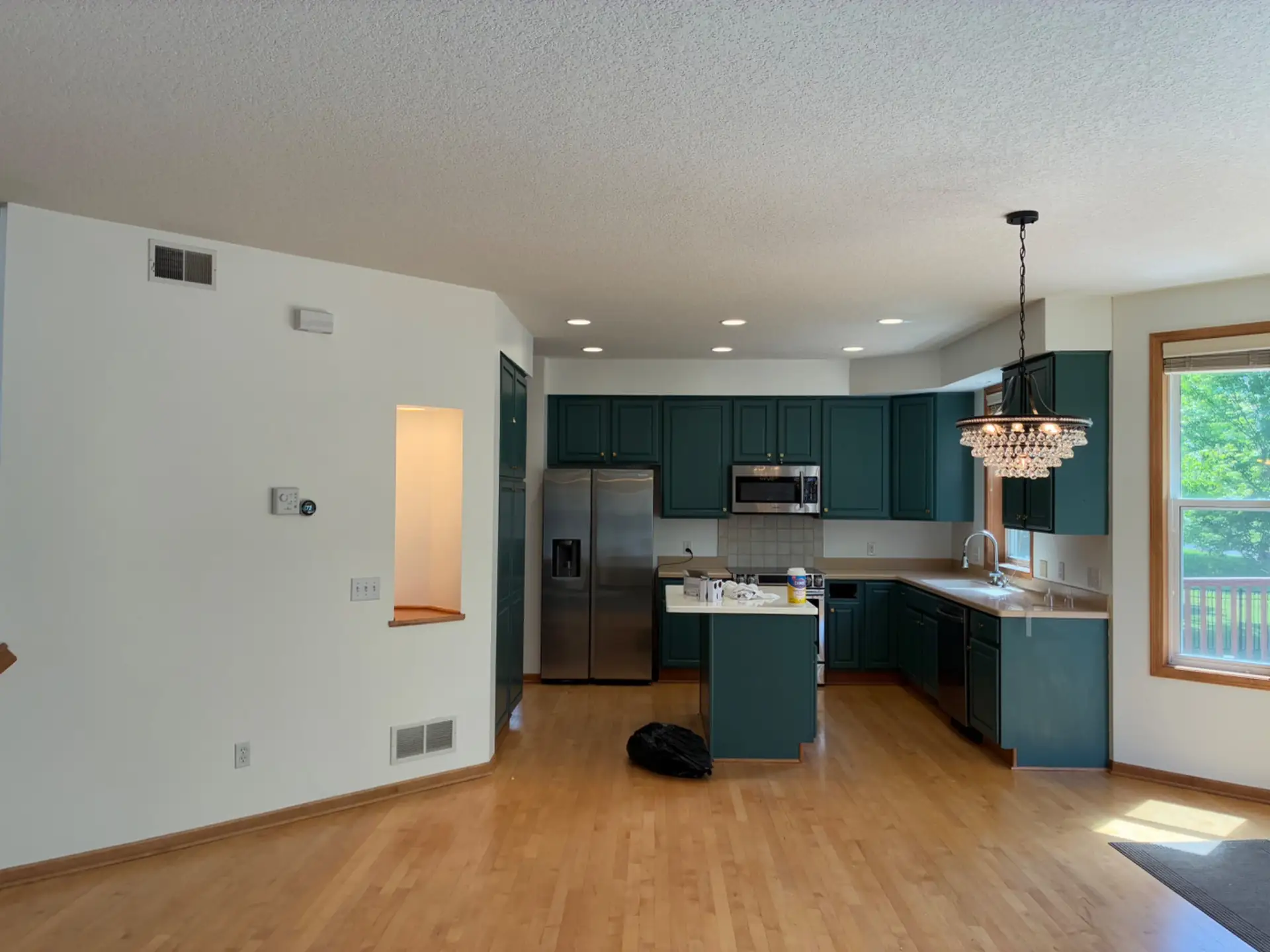 Kitchen cabinets refinished in deep green by Pro Painting Jr